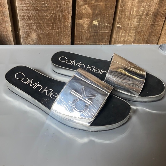 Calvin Klein Shoes - Calvin Klein silver metallic slides shoes size 9 Sandals